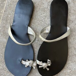 Cute black flip flops with toe strap with rhinestone skull and cross bones